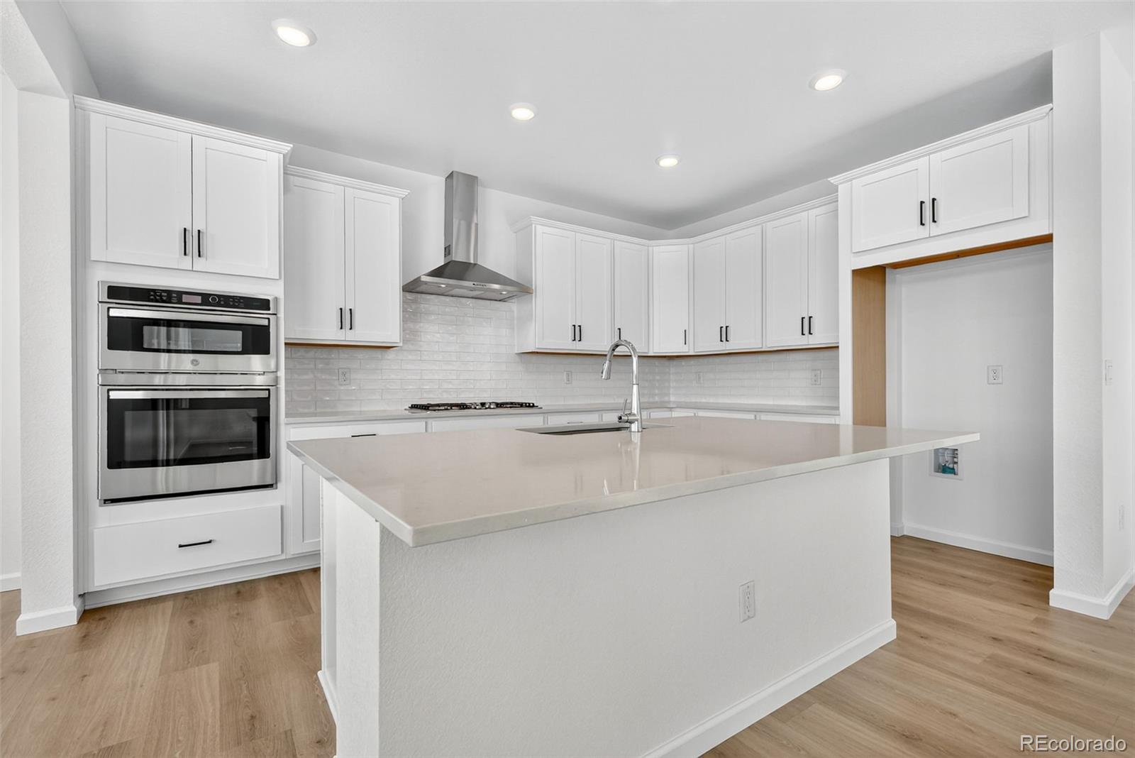 4297 Ridgewalk Point Castle Rock, CO 80108 - Photo 19 of 50 a kitchen with stainless steel appliances granite countertop a sink and a stove top oven