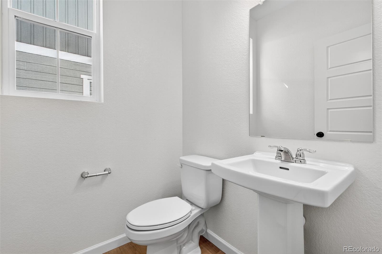4297 Ridgewalk Point Castle Rock, CO 80108 - Photo 21 of 50 a bathroom with a sink a toilet and a mirror