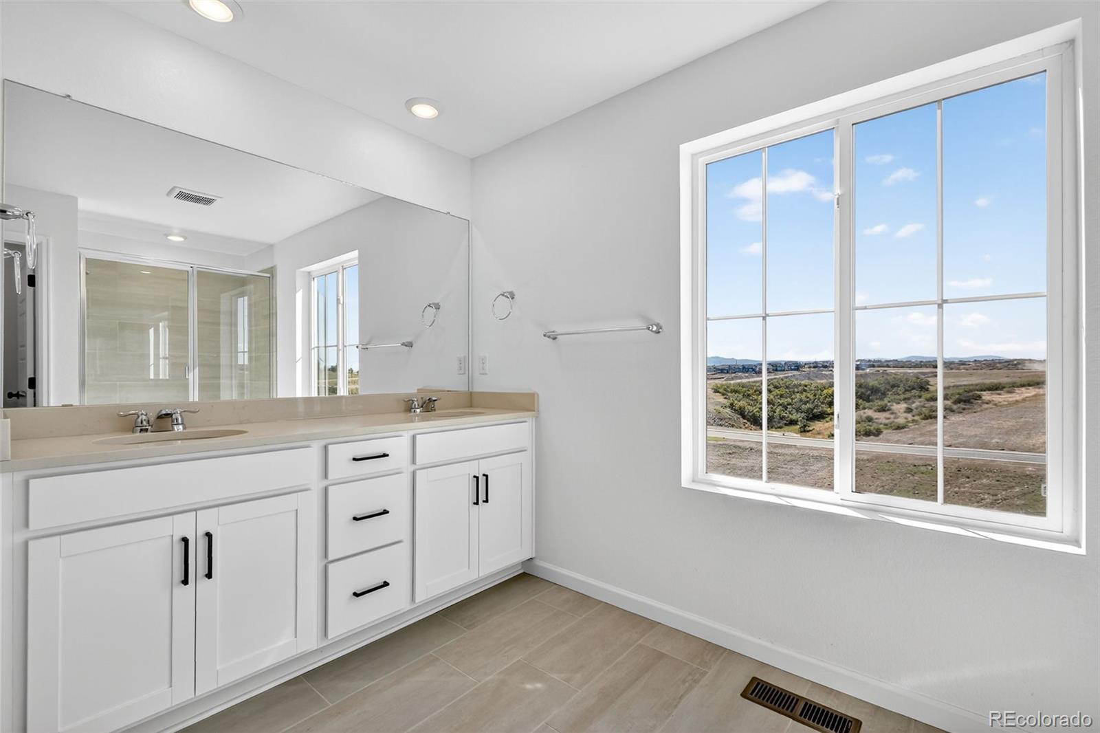 4297 Ridgewalk Point Castle Rock, CO 80108 - Photo 23 of 50 a spacious bathroom with double vanity and a large mirror