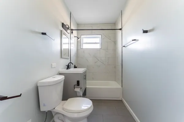 a white toilet sitting next to a bathroom sink