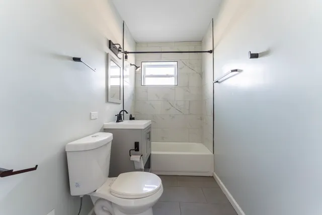 a white toilet sitting next to a bathroom sink