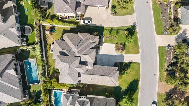 an aerial view of residential houses with outdoor space