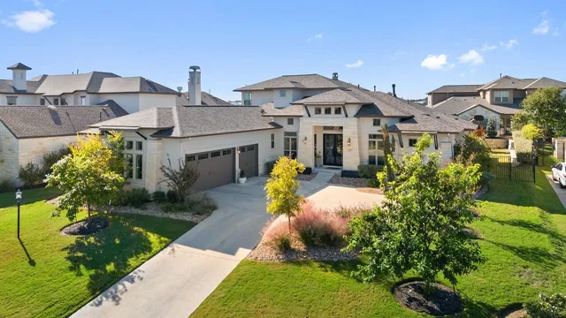 a front view of a house with garden and plants