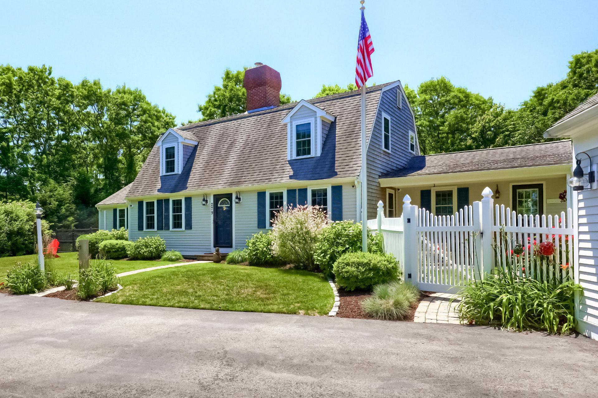 a front view of house with yard and green space