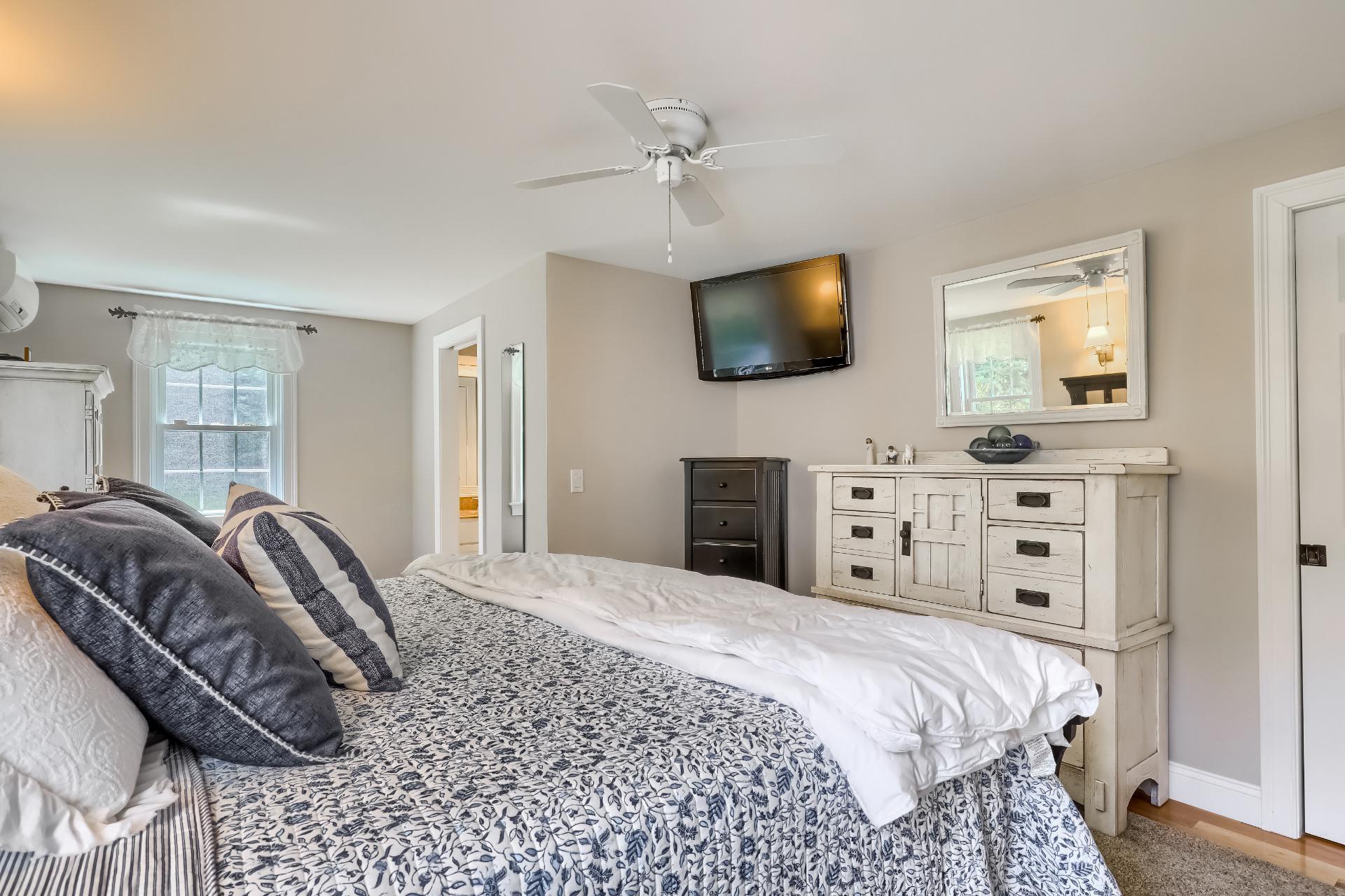 279 Service Road East Sandwich, MA 02537 - Photo 17 of 44 a bedroom with a large bed and a flat screen tv