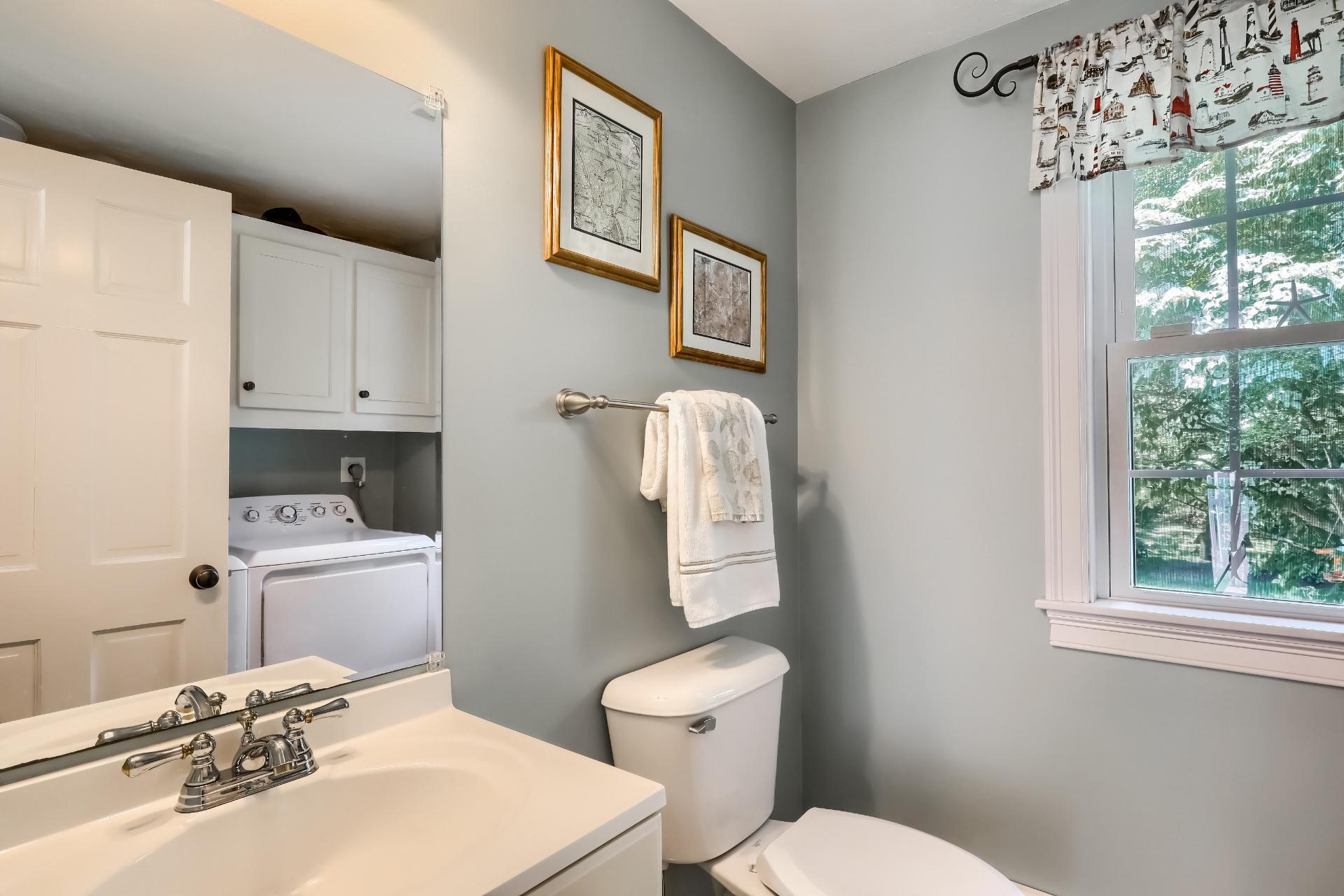 279 Service Road East Sandwich, MA 02537 - Photo 20 of 44 a bathroom with a sink a toilet and a window