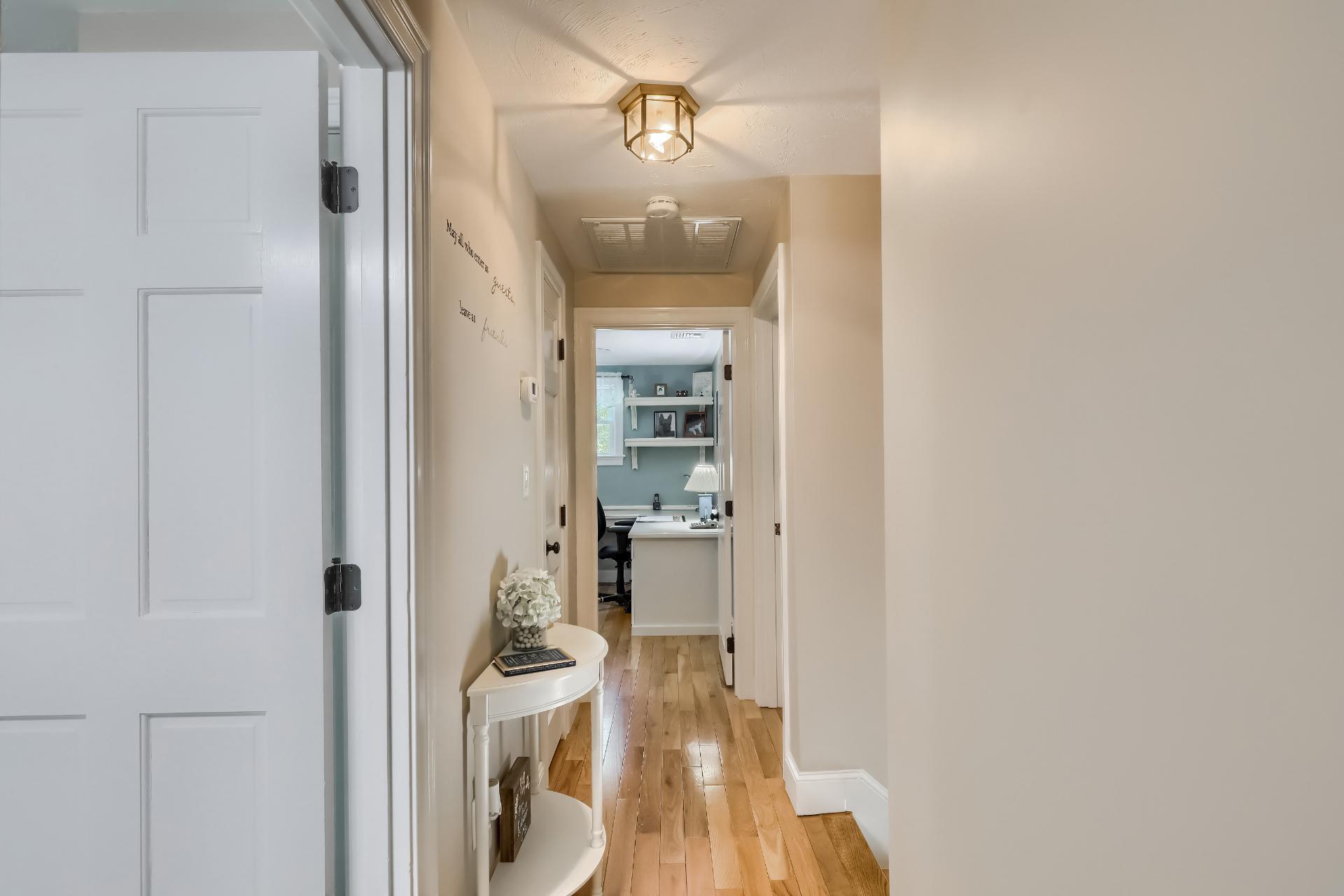 279 Service Road East Sandwich, MA 02537 - Photo 26 of 44 a view of a hallway with wooden floor and a bathroom