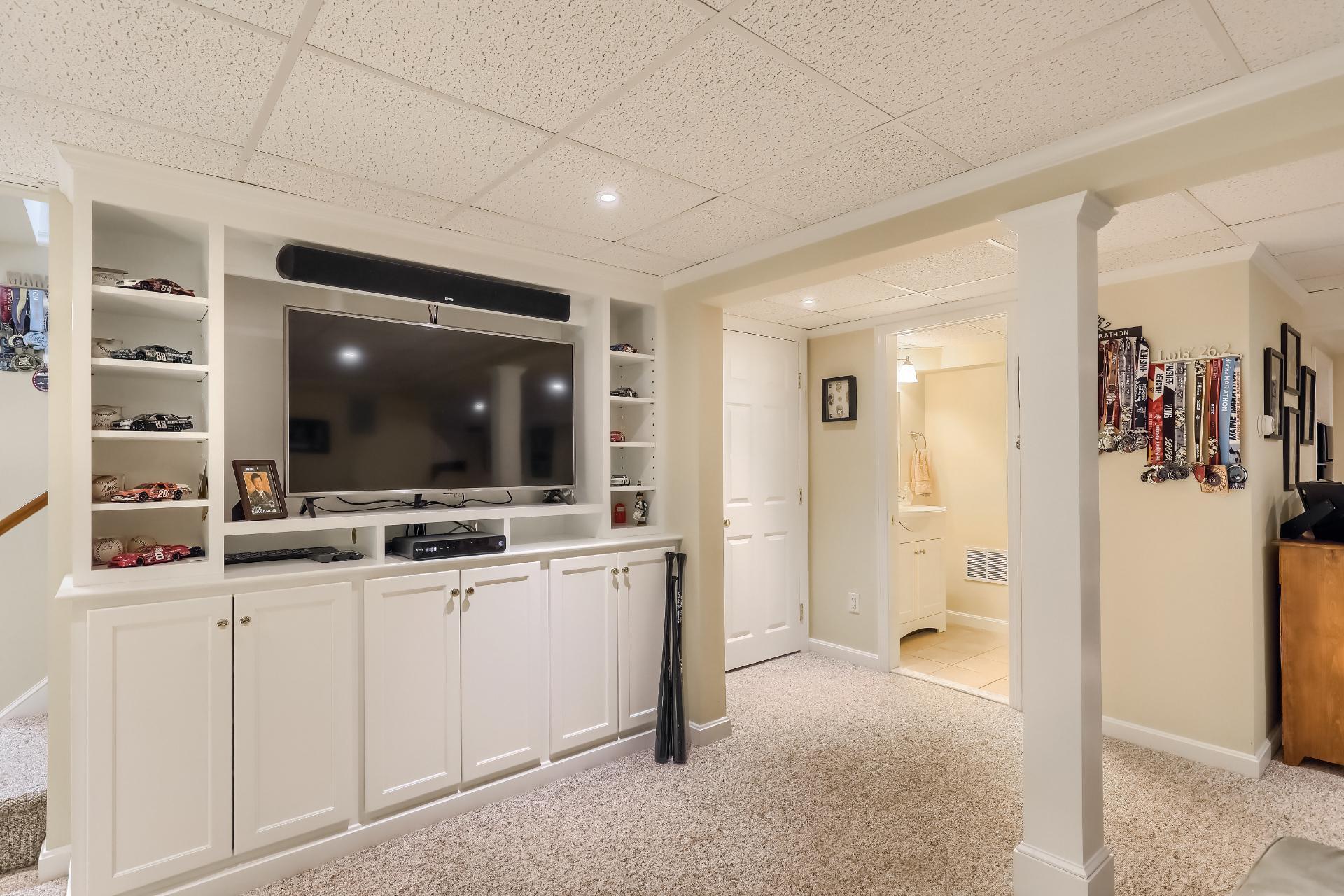 279 Service Road East Sandwich, MA 02537 - Photo 30 of 44 a living room with a flat screen tv and a view of bathroom