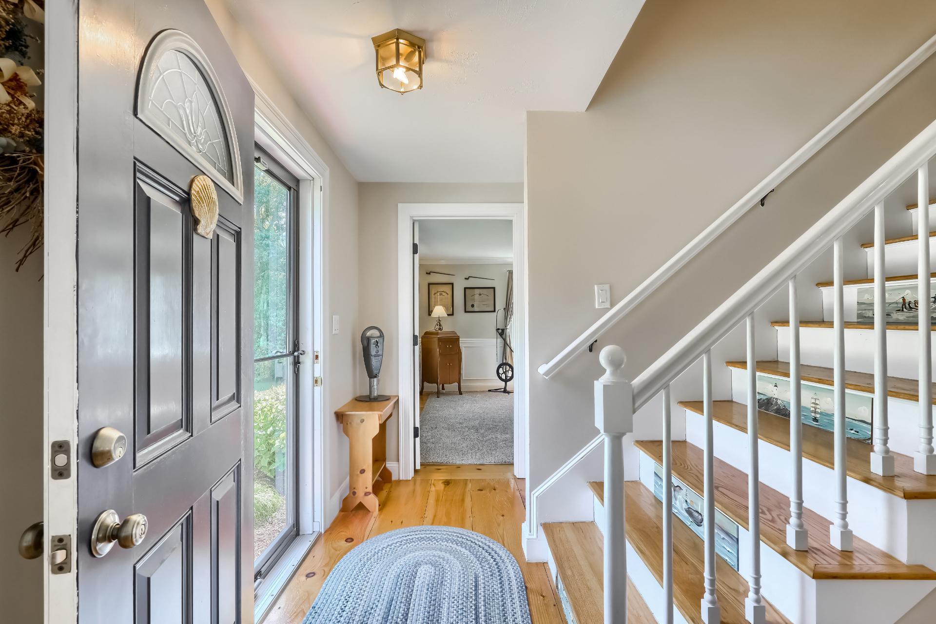 279 Service Road East Sandwich, MA 02537 - Photo 5 of 44 a view of staircase with railing and frames on wall