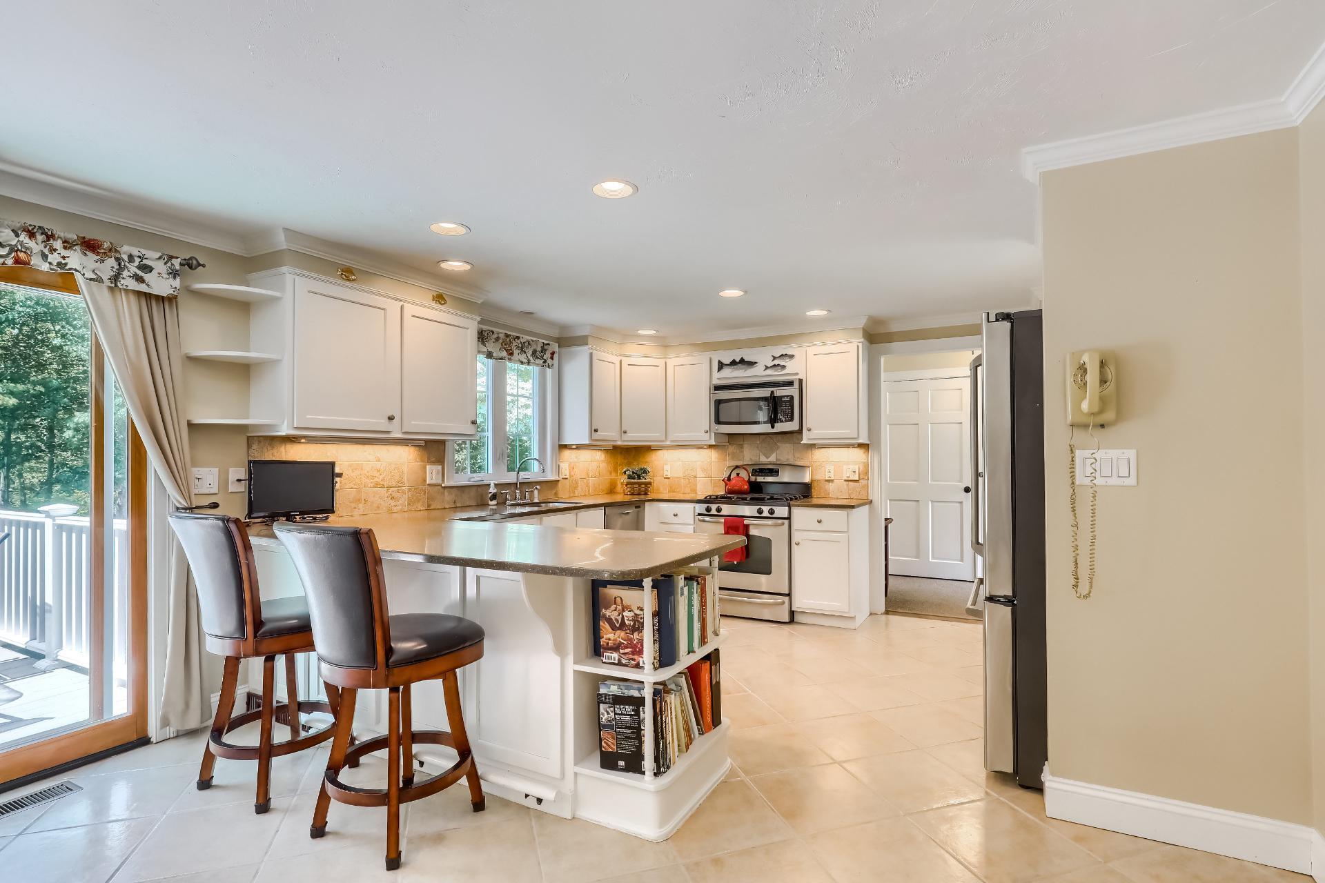 279 Service Road East Sandwich, MA 02537 - Photo 9 of 44 a living room with stainless steel appliances kitchen island granite countertop furniture and a refrigerator