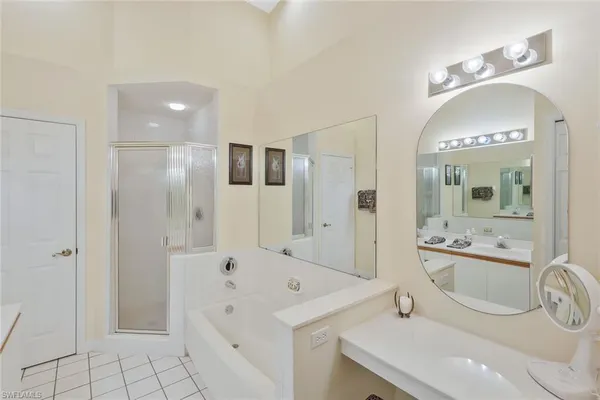 a en suite bathroom with a sink double vanity and a mirror