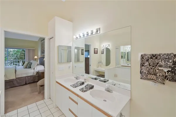 a bedroom with two beds and a chandelier