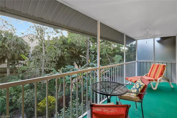 a balcony with table and chairs