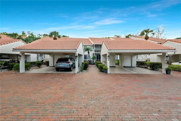 a car parked in front of house with a yard