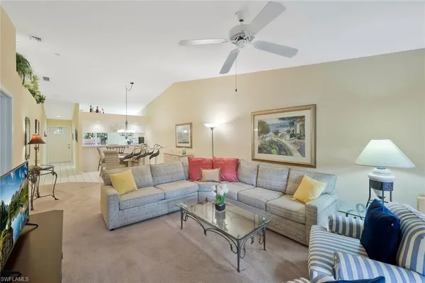 a living room with furniture and a lamp