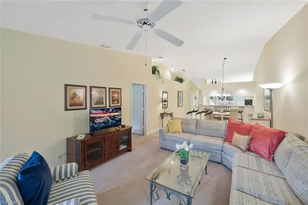 a living room with furniture a rug and white walls