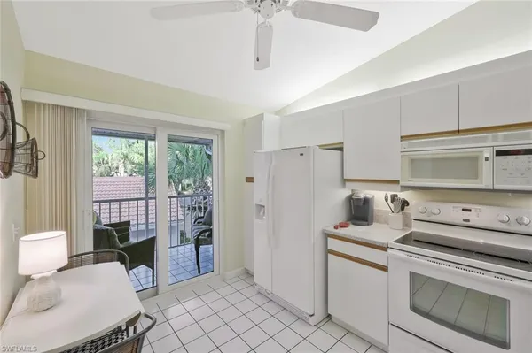a kitchen with a stove and white cabinets