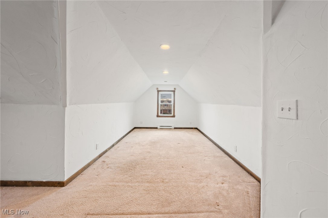 4146 Wyncote Road South Euclid, OH 44121 - Photo 16 of 20 Additional living space with baseboards, lofted ceiling, a baseboard heating unit, and carpet