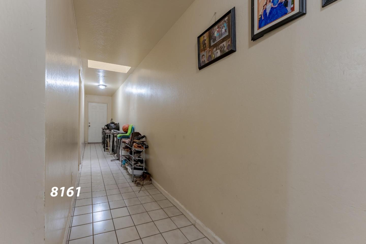 8151 Forest Street Gilroy, CA 95020 - Photo 14 of 43 a view of a hallway with wooden floor