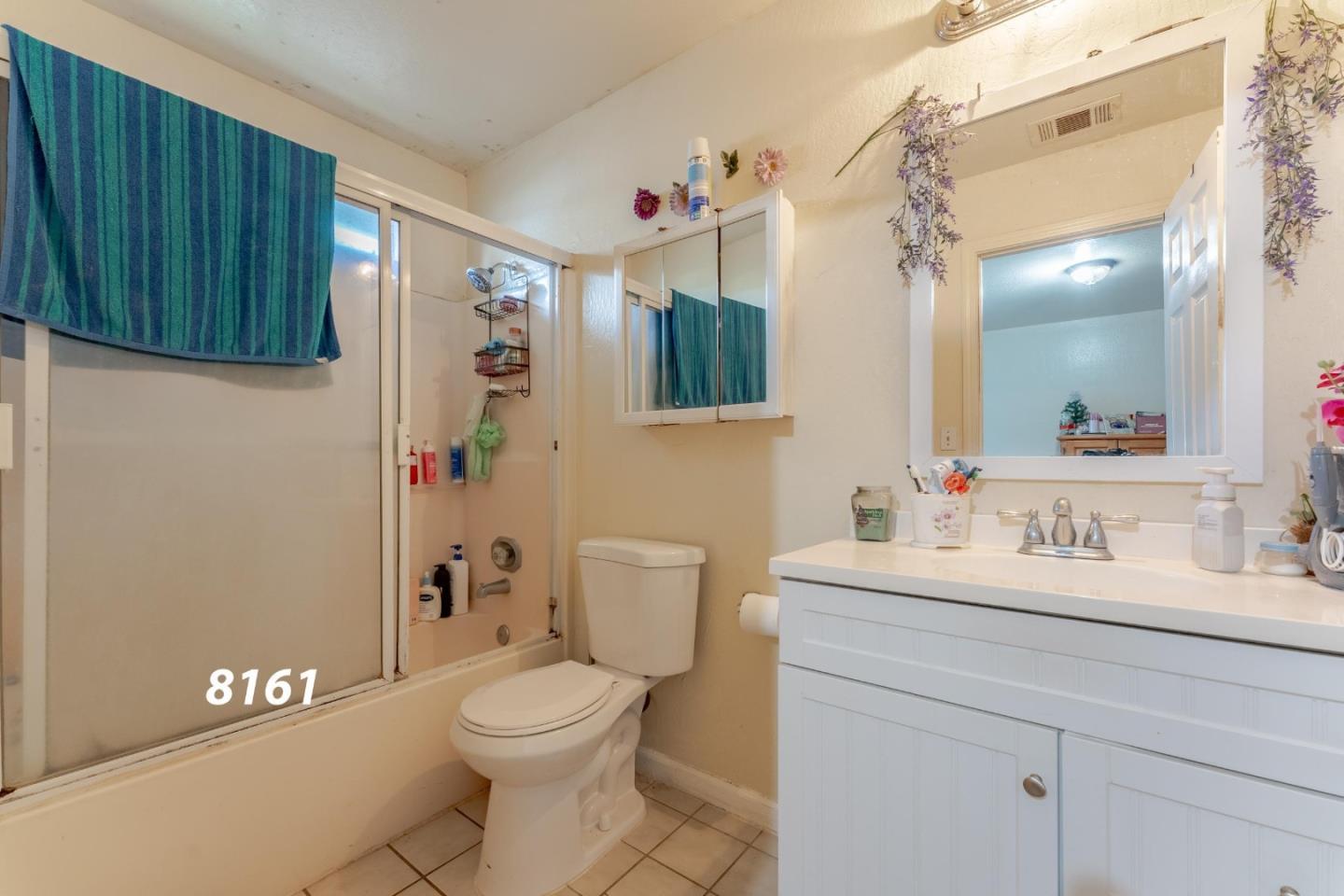 8151 Forest Street Gilroy, CA 95020 - Photo 16 of 43 a bathroom with a toilet a sink and a mirror