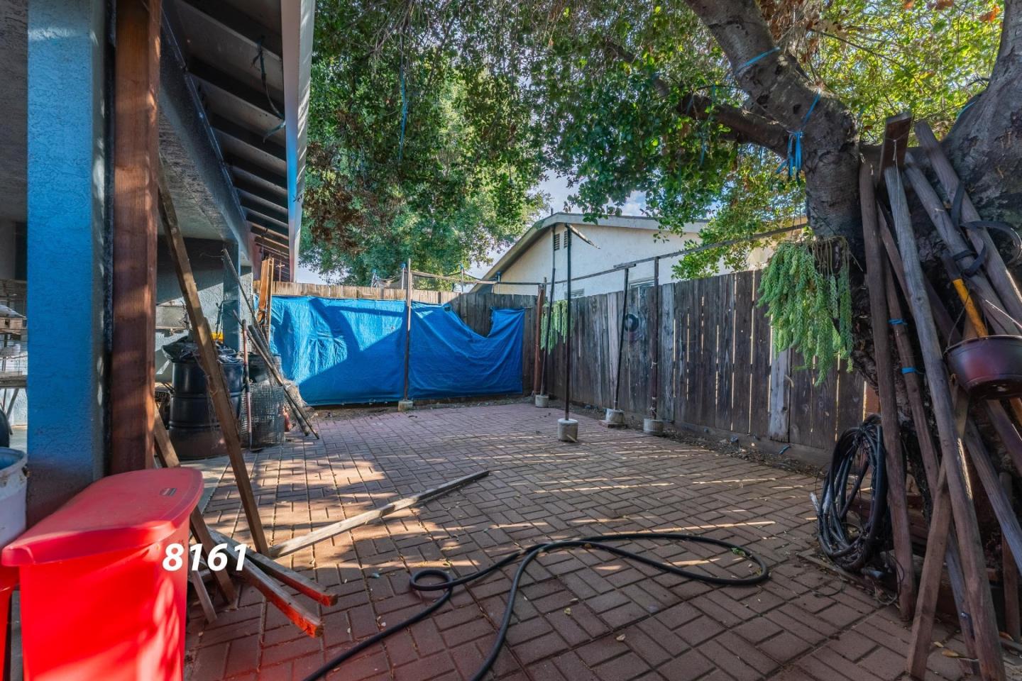 8151 Forest Street Gilroy, CA 95020 - Photo 19 of 43 a view of a house with backyard and wooden fence