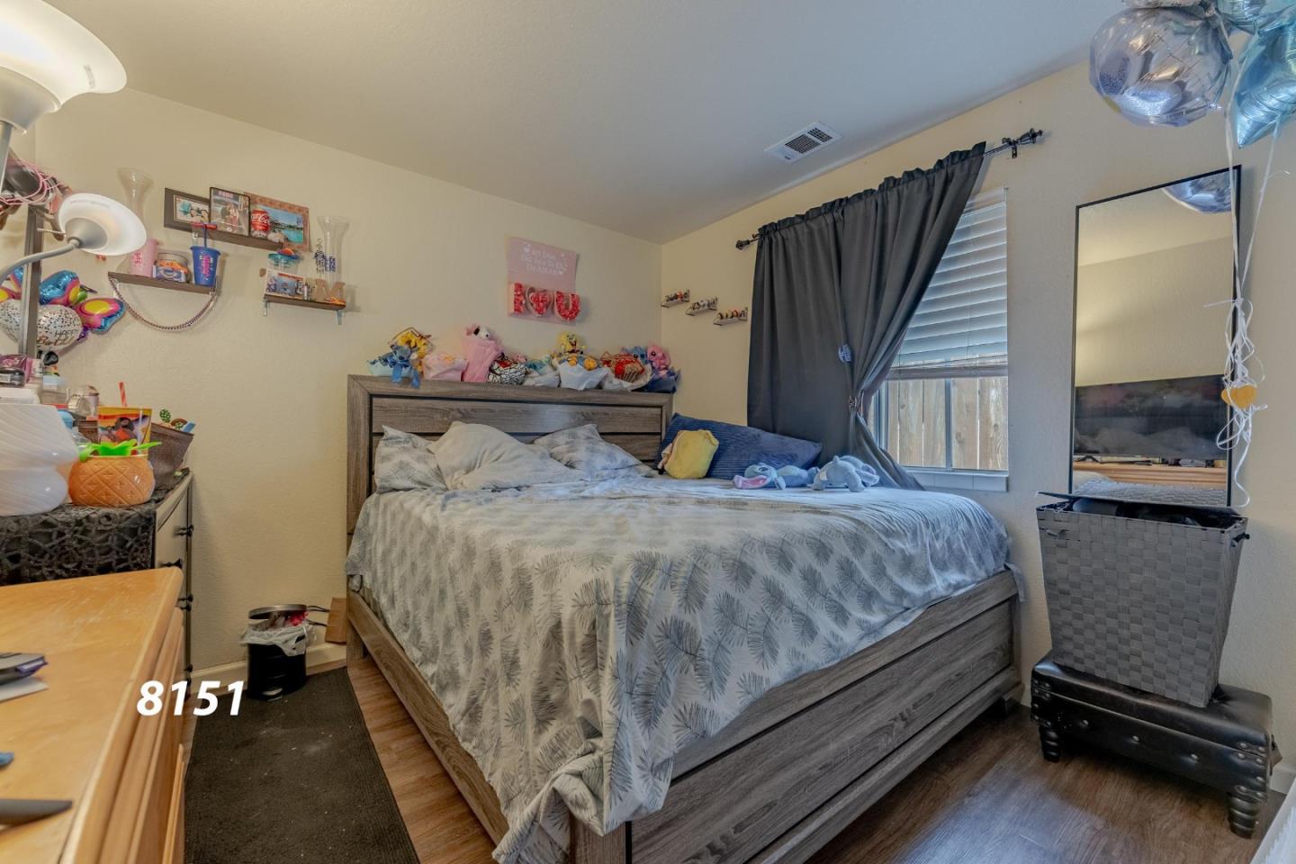 8151 Forest Street Gilroy, CA 95020 - Photo 21 of 43 a bed sitting in a bedroom next to a window