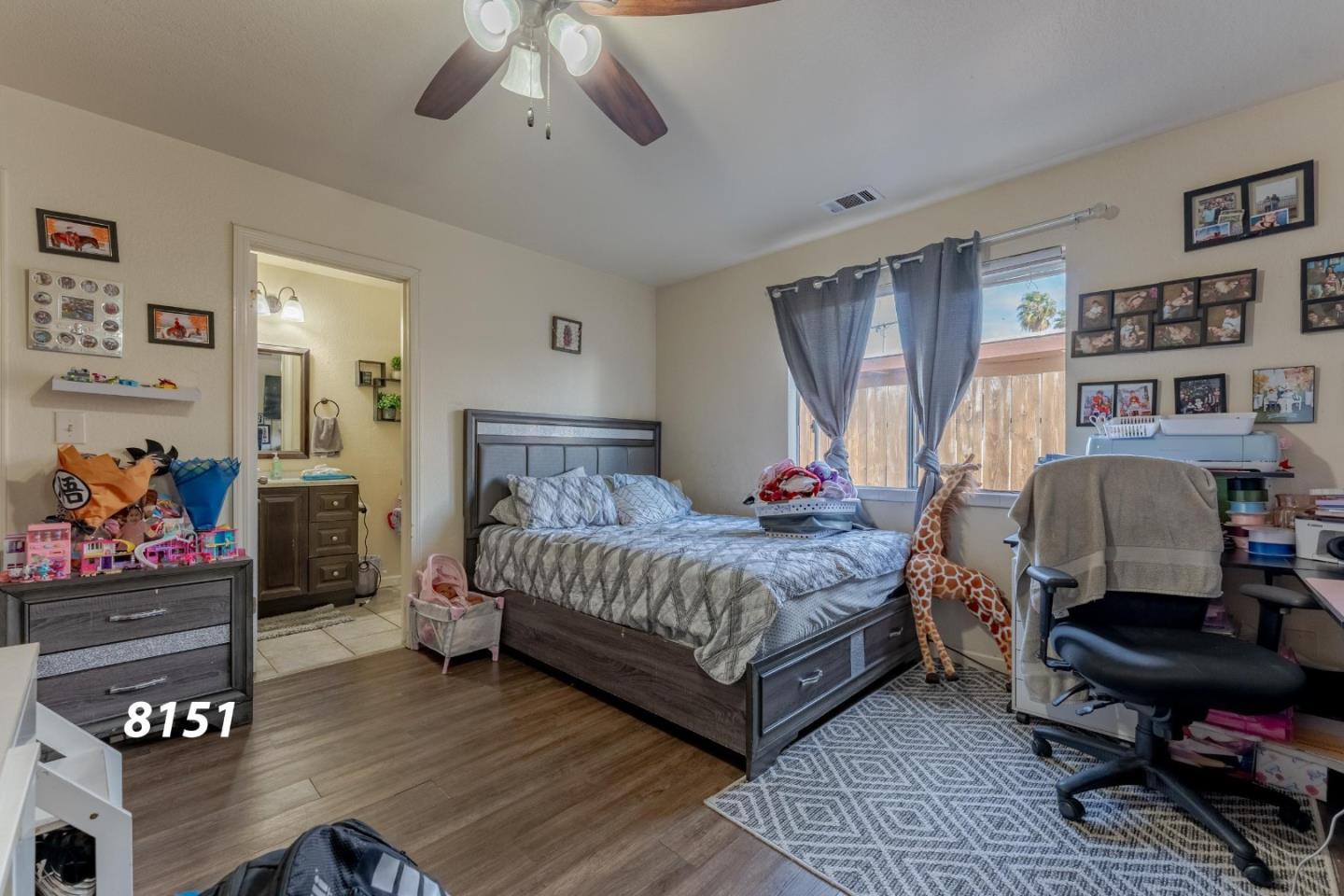 8151 Forest Street Gilroy, CA 95020 - Photo 23 of 43 a bedroom with a bed and wooden floor
