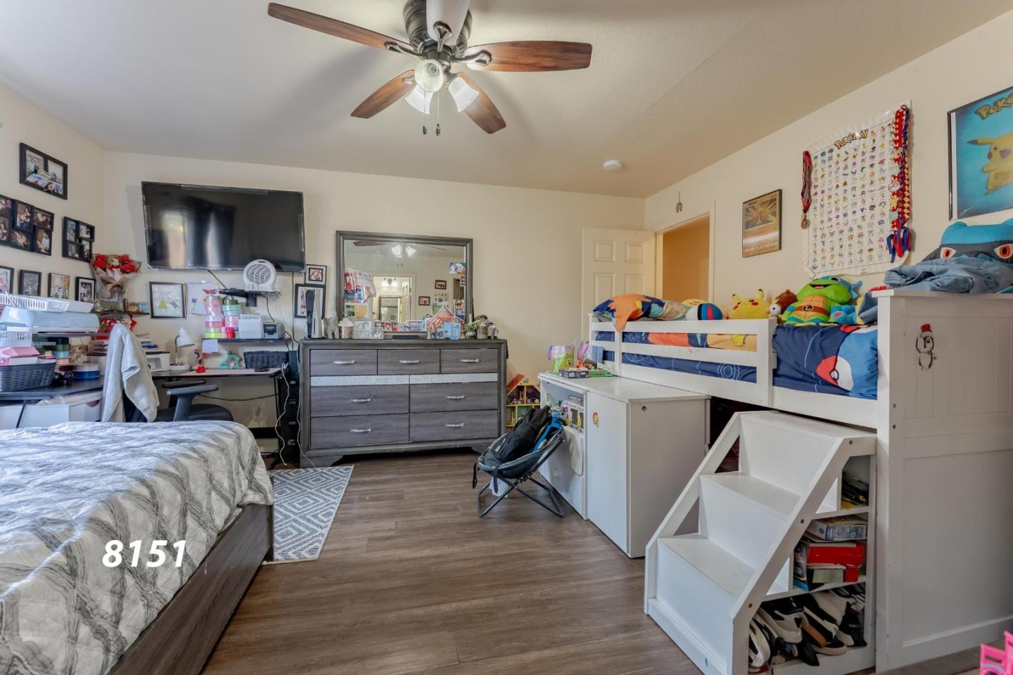 8151 Forest Street Gilroy, CA 95020 - Photo 25 of 43 a bedroom with a bed and a chandelier