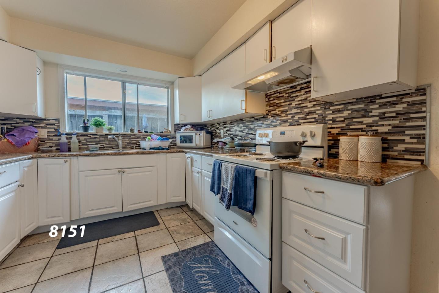 8151 Forest Street Gilroy, CA 95020 - Photo 29 of 43 a kitchen with a sink cabinets and window