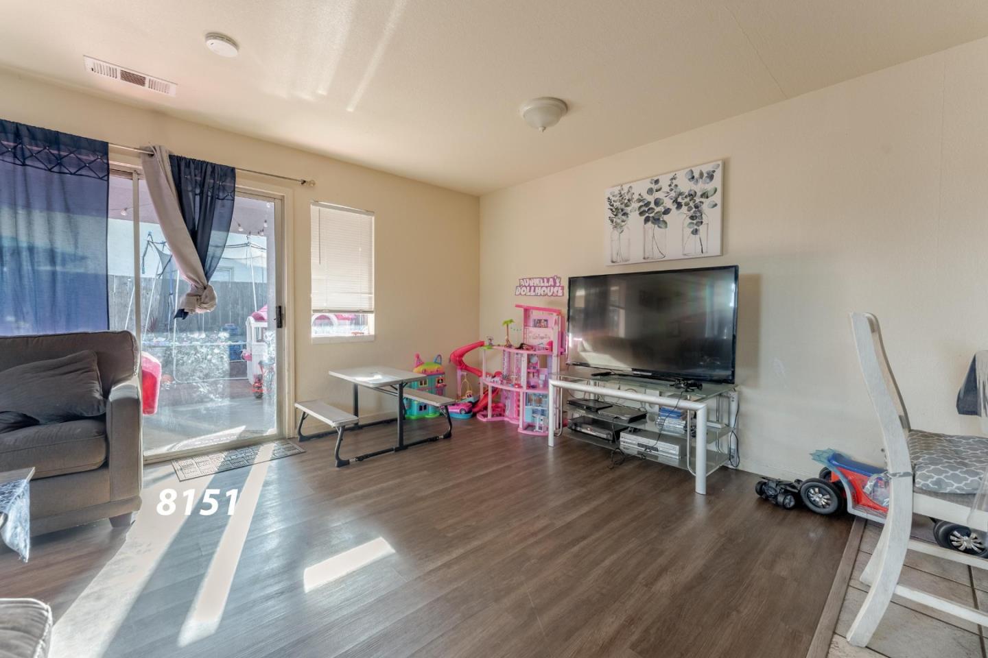 8151 Forest Street Gilroy, CA 95020 - Photo 32 of 43 a living room with furniture and a flat screen tv