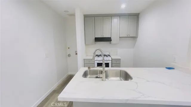 a kitchen with a sink and cabinets