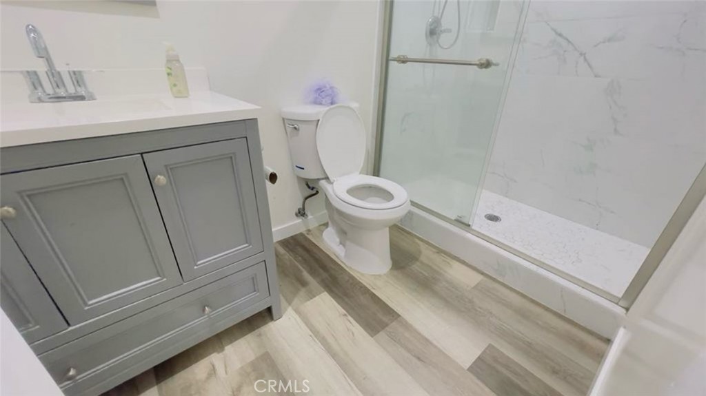 1458 West Summit Street, Unit E Long Beach, CA 90810 - Photo 4 of 7 a bathroom with a sink a toilet and a shower