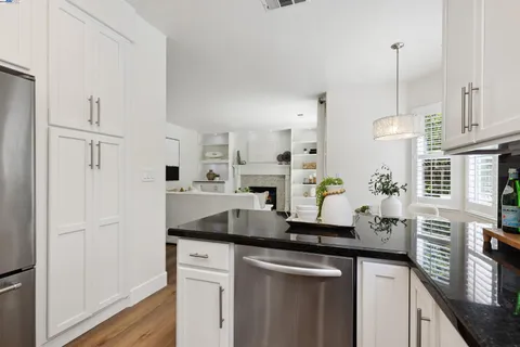 a kitchen with stainless steel appliances a sink and a refrigerator