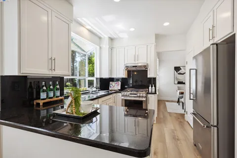 a kitchen with refrigerator and window