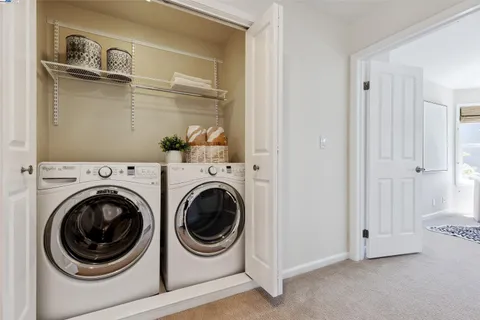 a view of a hallway with washer and dryer