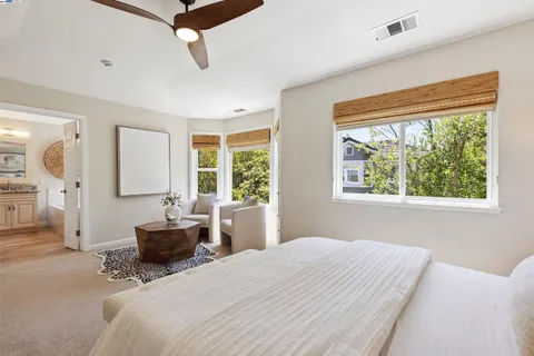 a bedroom with a bed couch and window