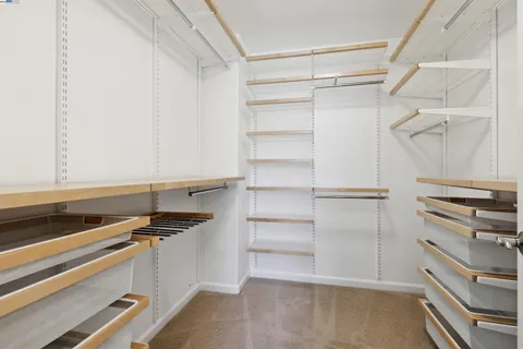 a kitchen with a refrigerator and a stove top oven