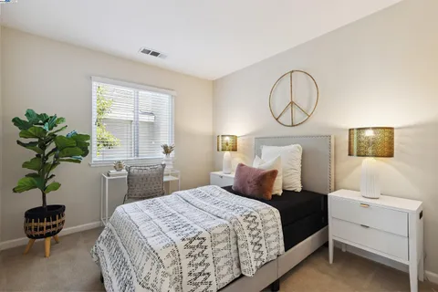 a bedroom with a bed and a potted plant