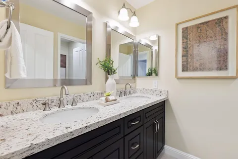 a bathroom with a sink double vanity and a mirror