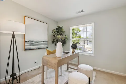 a view of a dining room with furniture and a window