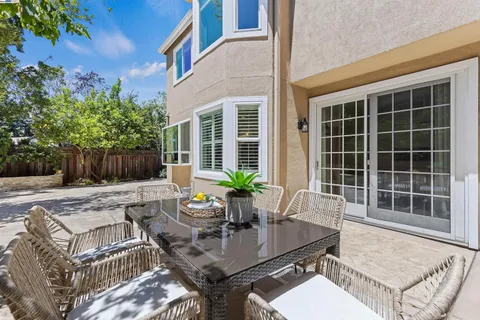 a view of a house with backyard and sitting area
