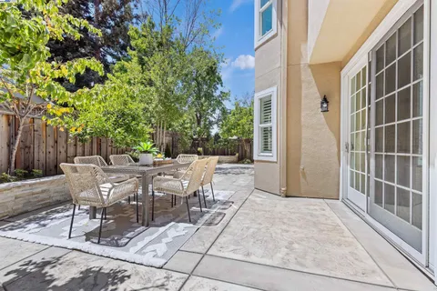 a view of a patio with a table and chairs and couches