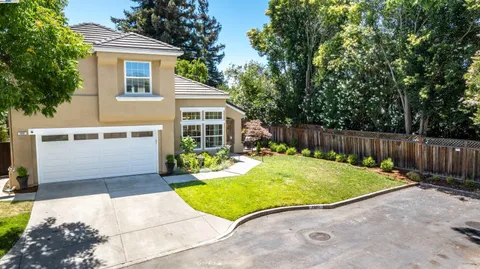 a view of backyard with a garden and trees