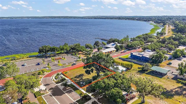 an aerial view of a house with a garden and lake view