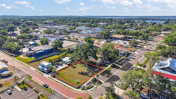 an aerial view of a residential houses with outdoor space and swimming pool