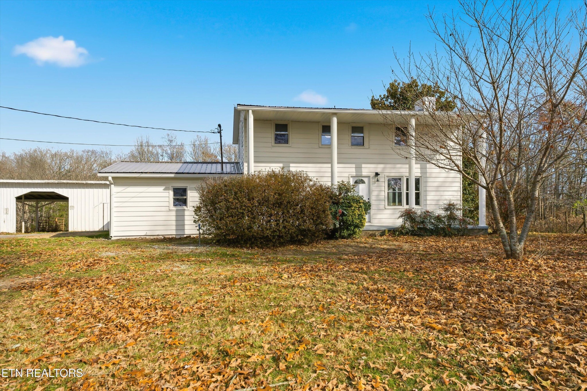 a front view of a house with a garden and yard