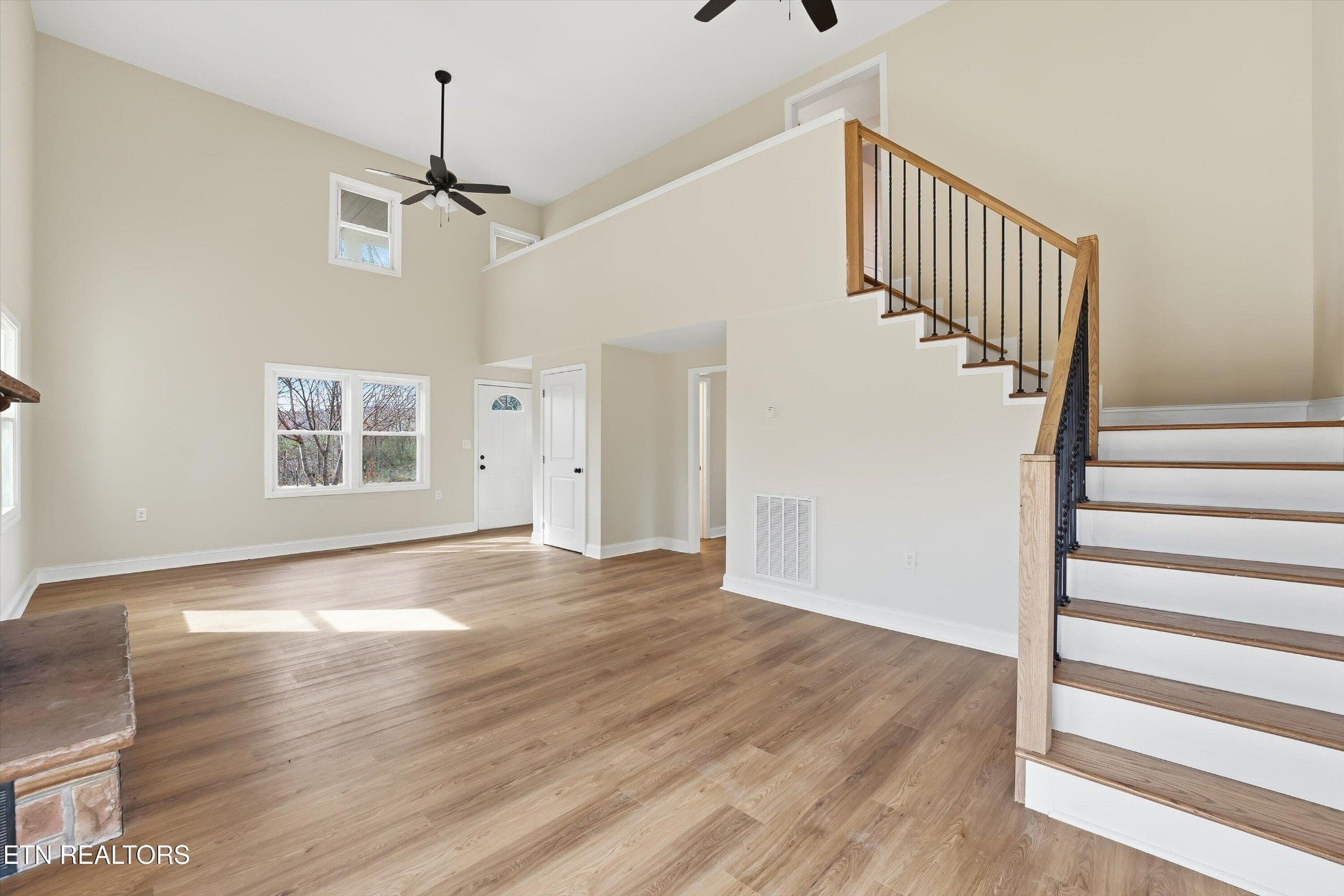 567 Dogwood Road Rockwood, TN 37854 - Photo 7 of 48 a view of an empty room with wooden floor ceiling fan and windows