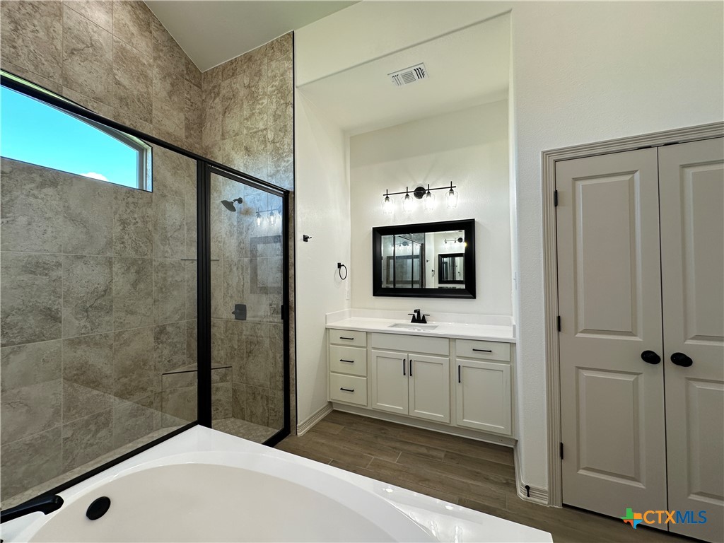 4521 Agave Trail Temple, TX 76502 - Photo 13 of 25 a bathroom with a tub sink and mirror