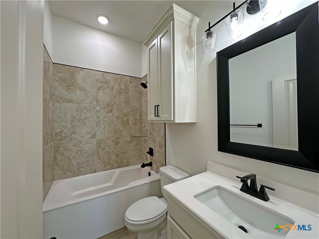 4521 Agave Trail Temple, TX 76502 - Photo 20 of 25 a bathroom with a bathtub shower sink vanity mirror and toilet