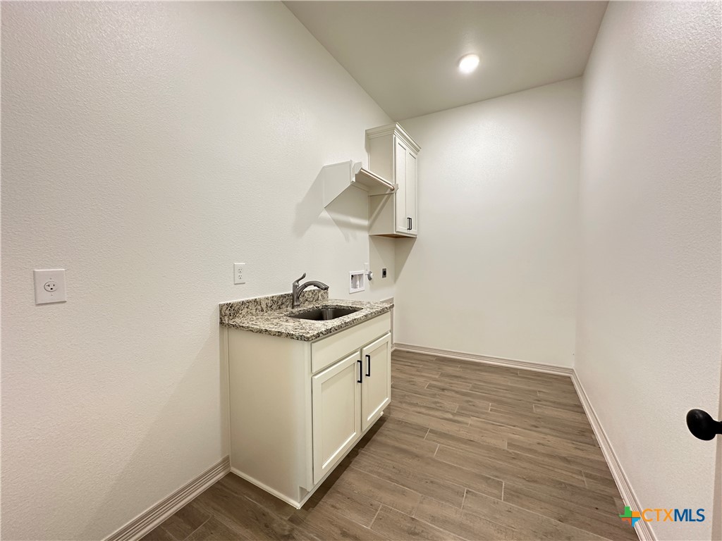 4521 Agave Trail Temple, TX 76502 - Photo 23 of 25 a kitchen with a sink cabinets and a wooden floor